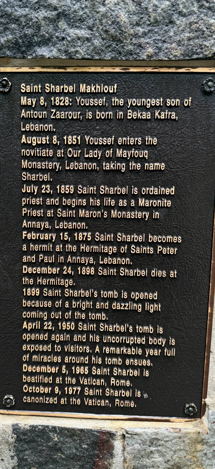 Bronze plaque describing the life of Saint Charbel Makhlouf