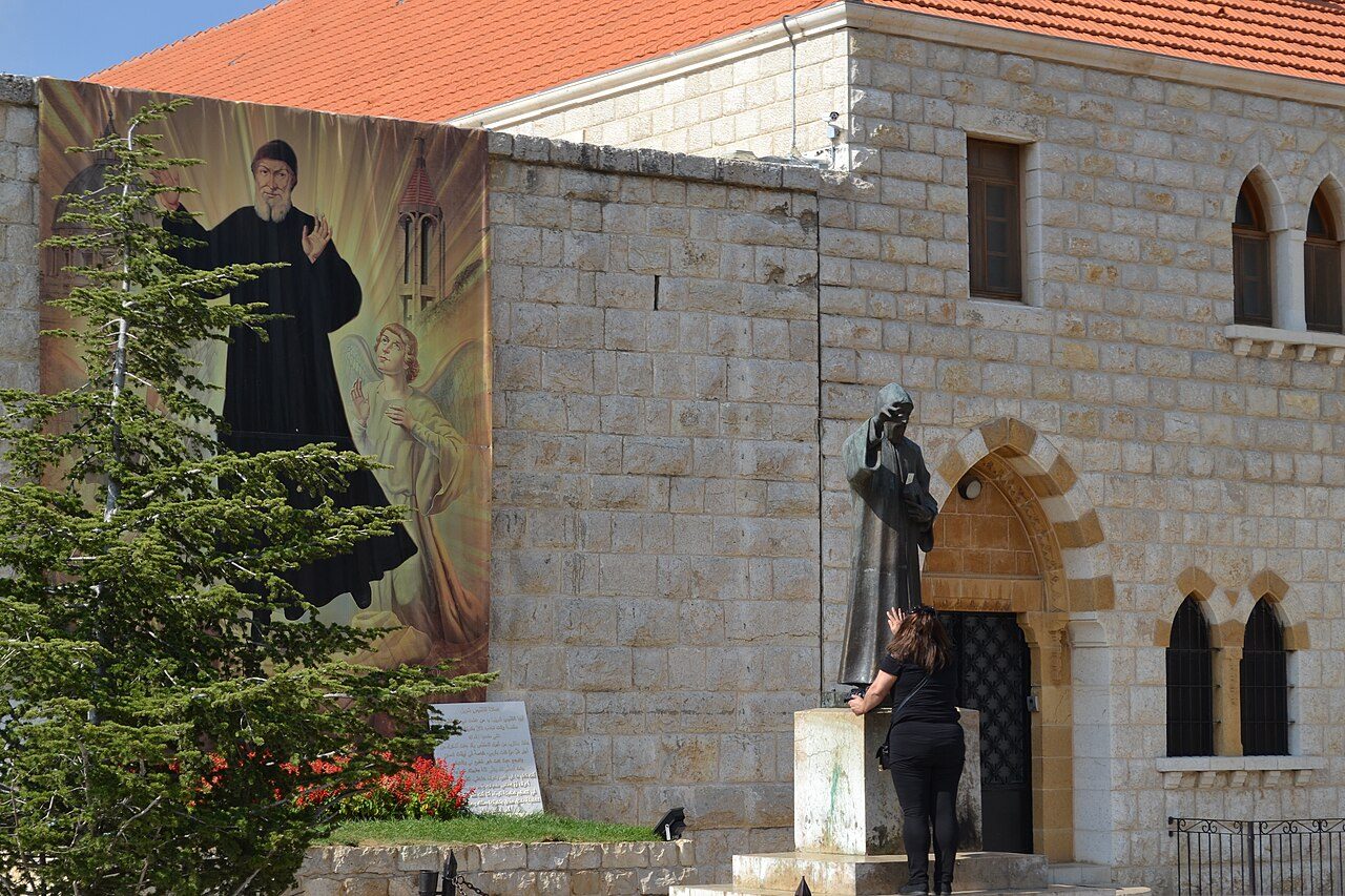 The church entrance with his statue and a great icon on the wall.